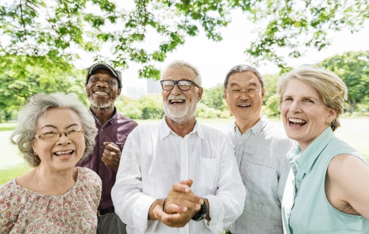 Residents socializing in the dining room at an Opal Senior Living community in Florida